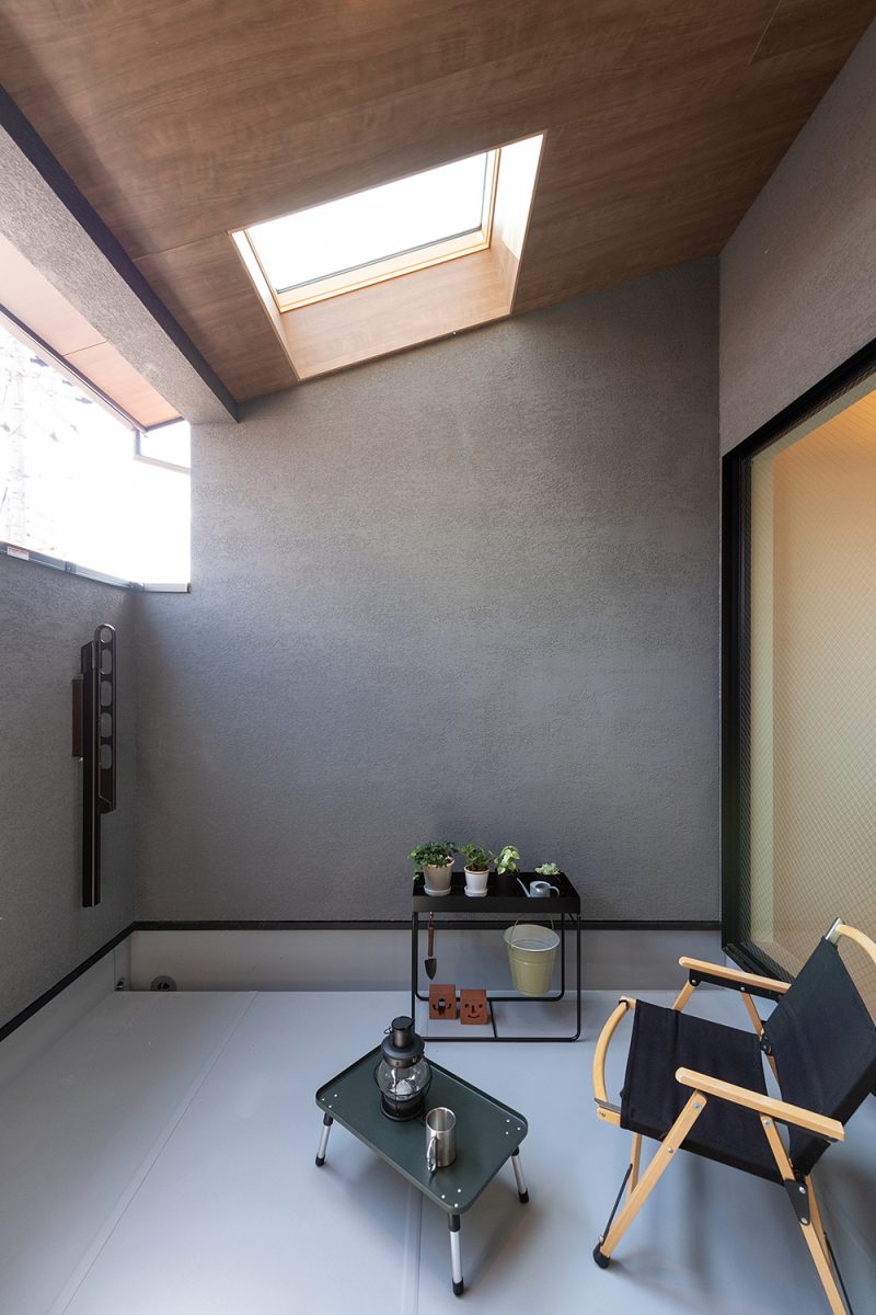 外からの視線を遮ったバルコニーは、家の中で過ごすようなリラックス感が得られる空間です。手摺り壁の高さにもこだわり、軒天は玄関部分と同じく木のデザインに。物干しスペースとしても利用できるほか、トップライトから柔らかく光が差し込み居心地の良さを感じられます。