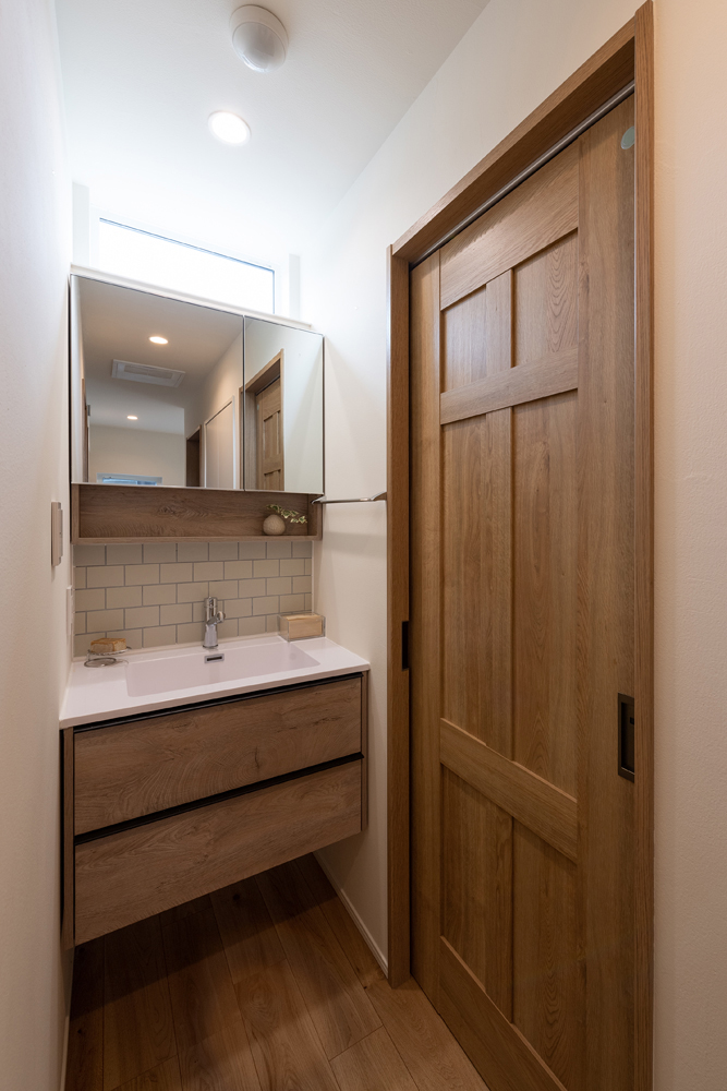 洗面台の上部には高窓を設け、暗くなりがちな廊下に自然光が入るように計画しました。